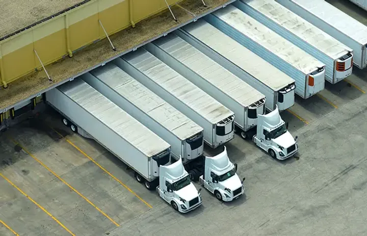 A fleet of commercial vehicles parked in a row, showcasing the importance of reliable wheel installations for fleet cost reduction.