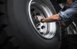A close-up of a wheel being installed on a commercial vehicle, showcasing the importance of proper installation techniques.